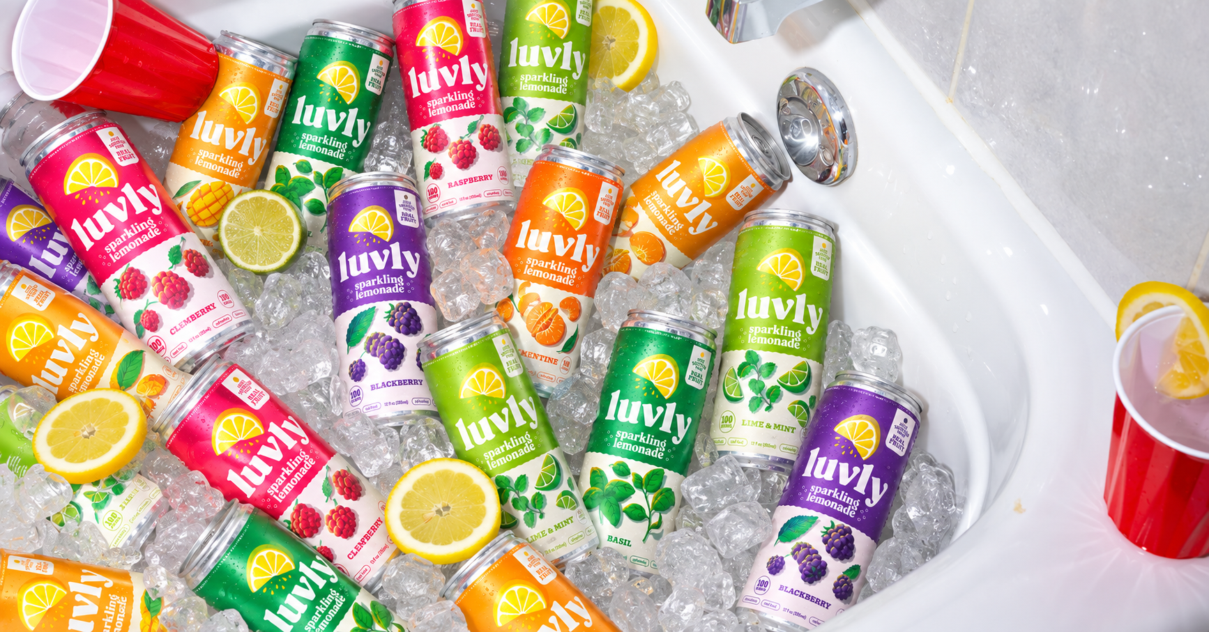 LUVLY sparkling lemonade chilled in an ice tub with citrus